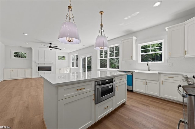 617 Dam Neck Rd, Virginia Beach, VA 23454 - kitchen featuring stainless steel appliances, recessed lighting, white cabinetry, light countertops, and a kitchen island