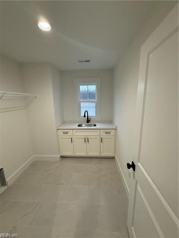 617 Dam Neck Rd, Virginia Beach, VA 23454 - laundry room with a sink, baseboards, and light tile patterned flooring