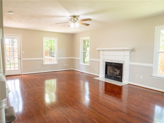 400 Fernwood Farms Rd, Chesapeake, VA 23320 - unfurnished living room featuring ceiling fan, wood finished floors, a fireplace with flush hearth, and baseboards