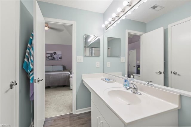 606 Queens Xing, Williamsburg, VA 23185 - ensuite bathroom with wood finished floors, vanity, and baseboards