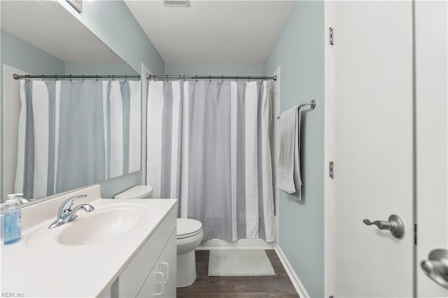 606 Queens Xing, Williamsburg, VA 23185 - full bathroom featuring vanity, wood finished floors, toilet, a textured ceiling, and baseboards