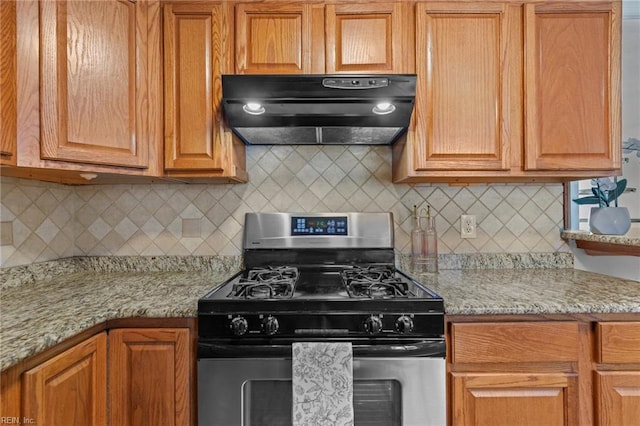 3521 Melinda Pl, Virginia Beach, VA 23452 - kitchen with under cabinet range hood, stainless steel range with gas cooktop, backsplash, and light stone counters