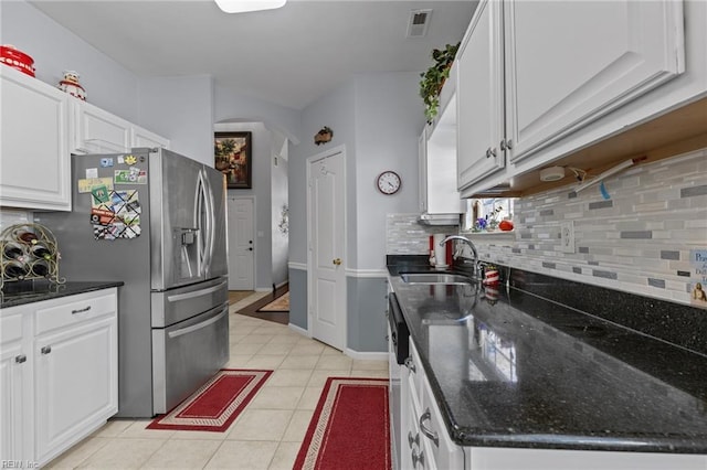 2673 Einstein Dr, Virginia Beach, VA 23456 - kitchen featuring tasteful backsplash, white cabinetry, a sink, and stainless steel fridge with ice dispenser