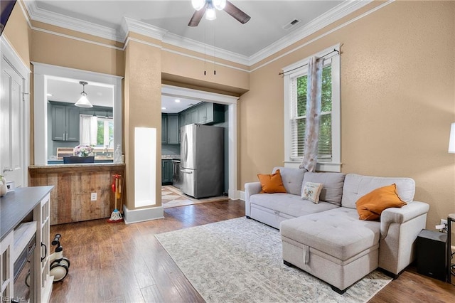 804 E Pembroke Ave, Hampton, VA 23669 - living room with healthy amount of natural light, a ceiling fan, wood finished floors, and ornamental molding