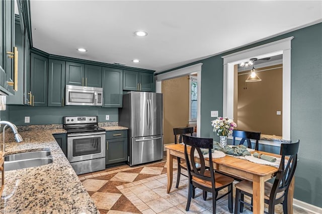 804 E Pembroke Ave, Hampton, VA 23669 - kitchen featuring appliances with stainless steel finishes, a sink, light stone counters, recessed lighting, and green cabinets