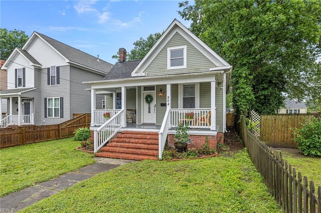 804 E Pembroke Ave, Hampton, VA 23669 - view of front of property with covered porch, a front lawn, roof with shingles, and a chimney