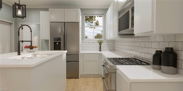 1548 Waltham Ln Unit A, Newport News, VA 23608 - kitchen with appliances with stainless steel finishes, a sink, backsplash, a center island with sink, and white cabinets