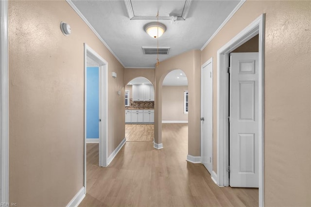 1204 Elder Ave, Chesapeake, VA 23325 - hall featuring arched walkways, light wood-type flooring, crown molding, attic access, and baseboards