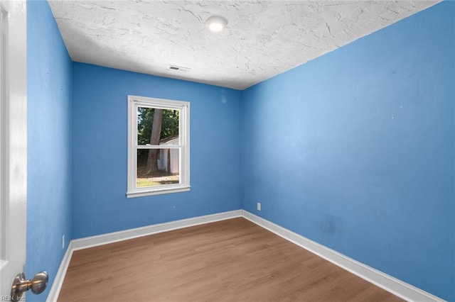 1204 Elder Ave, Chesapeake, VA 23325 - spare room with wood finished floors, baseboards, and a textured ceiling
