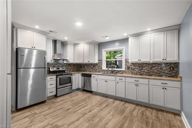 1204 Elder Ave, Chesapeake, VA 23325 - kitchen with stainless steel appliances, wall chimney range hood, a sink, light wood finished floors, and recessed lighting