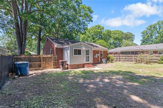 1204 Elder Ave, Chesapeake, VA 23325 - rear view of property featuring entry steps, board and batten siding, brick siding, central air condition unit, and a fenced backyard