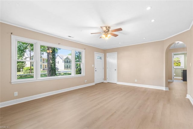 1204 Elder Ave, Chesapeake, VA 23325 - unfurnished living room with ornamental molding, light wood finished floors, arched walkways, ceiling fan, and baseboards