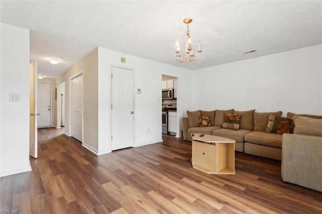 59 Terri Sue Ct, Hampton, VA 23666 - living area featuring a chandelier, wood finished floors, and baseboards