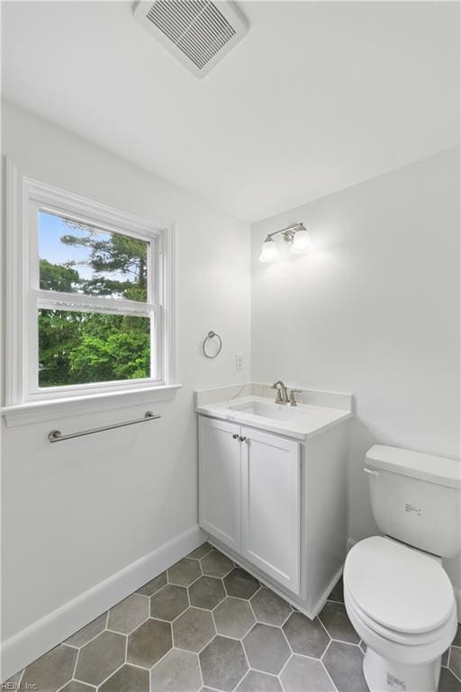 4328 Thoroughgood Dr, Virginia Beach, VA 23455 - half bathroom with vanity, toilet, tile patterned floors, and baseboards