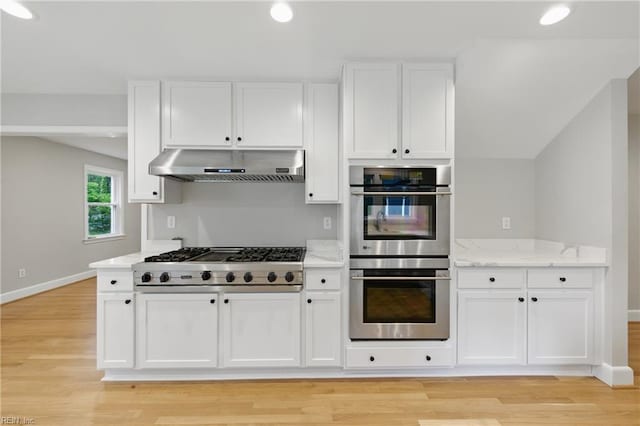 4328 Thoroughgood Dr, Virginia Beach, VA 23455 - kitchen with under cabinet range hood, cooktop, stainless steel double oven, white cabinetry, and baseboards