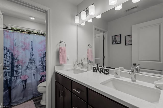 2011 River Pearl Way, Chesapeake, VA 23321 - bathroom featuring toilet, double vanity, and wood finished floors