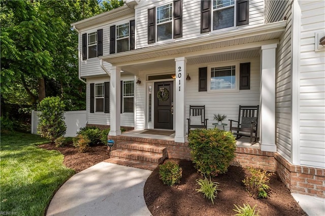 2011 River Pearl Way, Chesapeake, VA 23321 - doorway to property featuring covered porch and a lawn