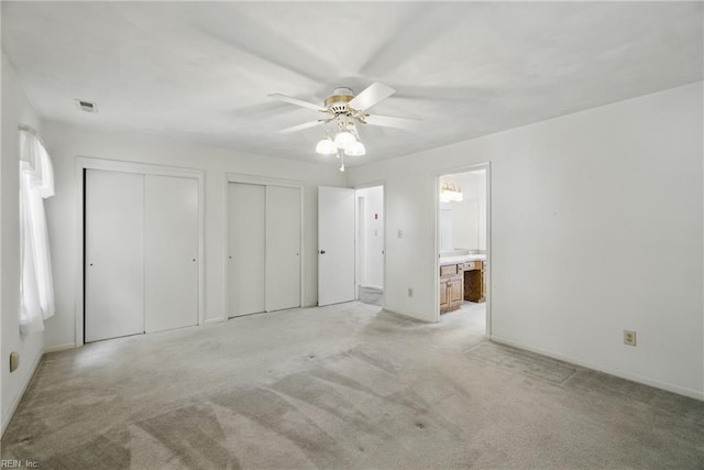 2520 Cantwell Rd, Virginia Beach, VA 23453 - unfurnished bedroom featuring two closets, light carpet, baseboards, connected bathroom, and ceiling fan