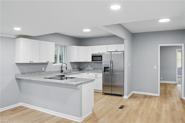6428 Hudson Ave, Norfolk, VA 23502 - kitchen with appliances with stainless steel finishes, a peninsula, light stone countertops, baseboards, and recessed lighting