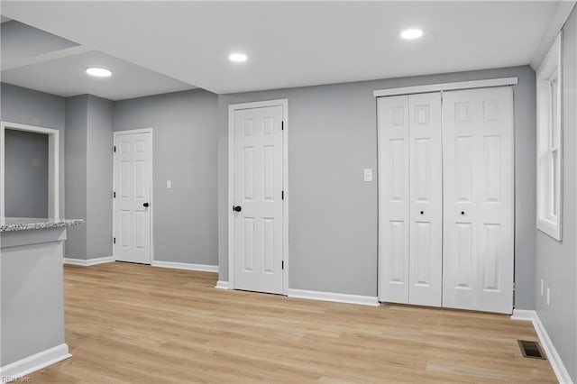 6428 Hudson Ave, Norfolk, VA 23502 - unfurnished bedroom with light wood-style floors, baseboards, recessed lighting, and two closets