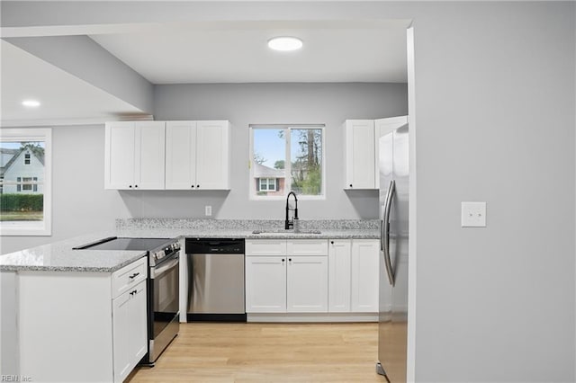 6428 Hudson Ave, Norfolk, VA 23502 - kitchen with appliances with stainless steel finishes, a sink, a peninsula, white cabinets, and light stone counters