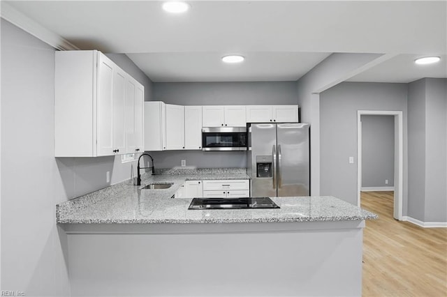 6428 Hudson Ave, Norfolk, VA 23502 - kitchen featuring appliances with stainless steel finishes, a sink, white cabinets, a peninsula, and light stone counters