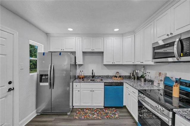 30 W Southampton Ave, Hampton, VA 23669 - kitchen with appliances with stainless steel finishes, a sink, white cabinets, dark wood-type flooring, and recessed lighting