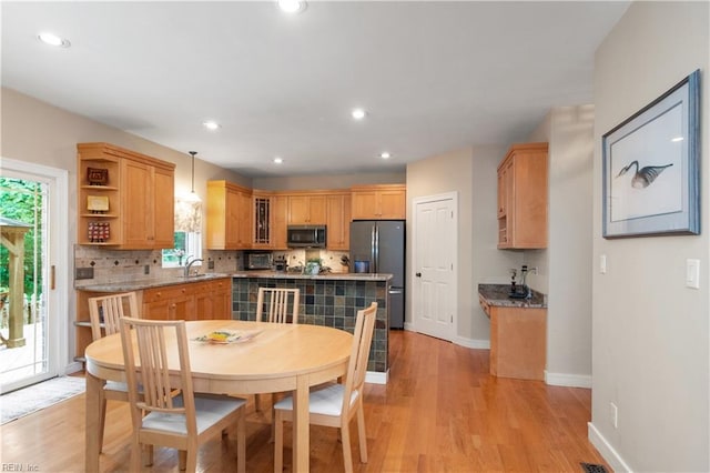 1301 Hawaiian Dr, Virginia Beach, VA 23451 - kitchen with appliances with stainless steel finishes, a sink, decorative backsplash, light wood-type flooring, and open shelves