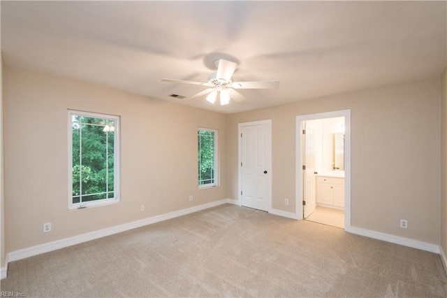 1301 Hawaiian Dr, Virginia Beach, VA 23451 - unfurnished bedroom featuring light carpet, baseboards, connected bathroom, and a ceiling fan