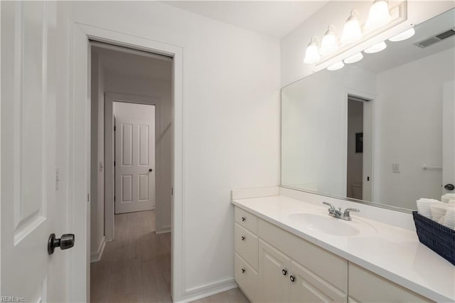 1301 Hawaiian Dr, Virginia Beach, VA 23451 - bathroom featuring vanity, wood finished floors, and baseboards