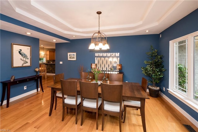 1301 Hawaiian Dr, Virginia Beach, VA 23451 - dining room featuring a tray ceiling, light wood-type flooring, a chandelier, baseboards, and recessed lighting