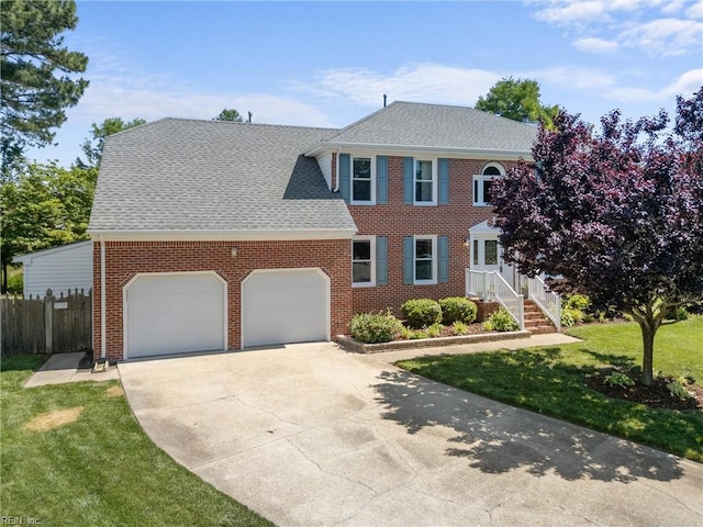 1217 Cogliandro Dr, Chesapeake, VA 23320 - colonial home with a garage, brick siding, concrete driveway, and roof with shingles