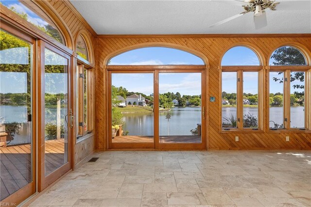 1217 Cogliandro Dr, Chesapeake, VA 23320 - unfurnished sunroom featuring wooden walls, stone tile flooring, and a water view