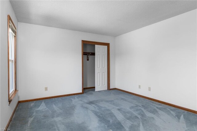 1217 Cogliandro Dr, Chesapeake, VA 23320 - unfurnished bedroom with carpet, baseboards, a closet, and a textured ceiling