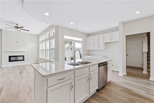 1400 Acadian Dr Unit A, Suffolk, VA 23434 - kitchen featuring stainless steel dishwasher, a sink, a center island with sink, baseboards, and a glass covered fireplace