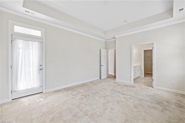 1400 Acadian Dr Unit A, Suffolk, VA 23434 - unfurnished bedroom featuring a raised ceiling, light colored carpet, crown molding, baseboards, and a walk in closet