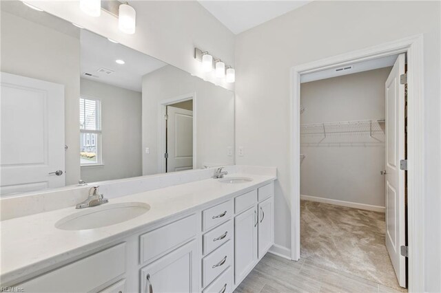 1400 Acadian Dr Unit A, Suffolk, VA 23434 - full bath with double vanity, a walk in closet, and baseboards