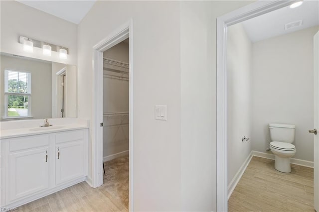 1400 Acadian Dr Unit A, Suffolk, VA 23434 - bathroom featuring vanity, toilet, a walk in closet, and baseboards