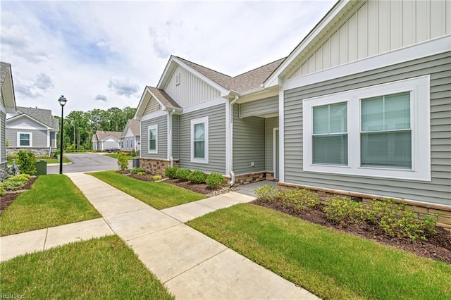 1400 Acadian Dr Unit A, Suffolk, VA 23434 - view of side of property featuring board and batten siding and a lawn