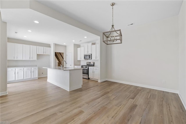 1400 Acadian Dr Unit A, Suffolk, VA 23434 - kitchen featuring appliances with stainless steel finishes, light wood-style floors, a sink, white cabinets, and recessed lighting