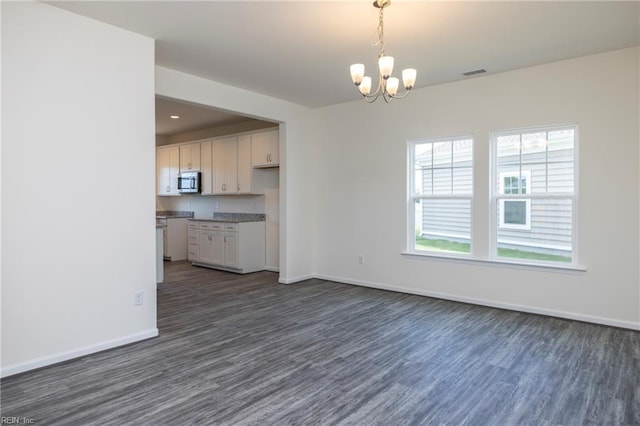 102 Corcoran Ln, Suffolk, VA 23434 - unfurnished living room with dark wood-type flooring, baseboards, a chandelier, and recessed lighting