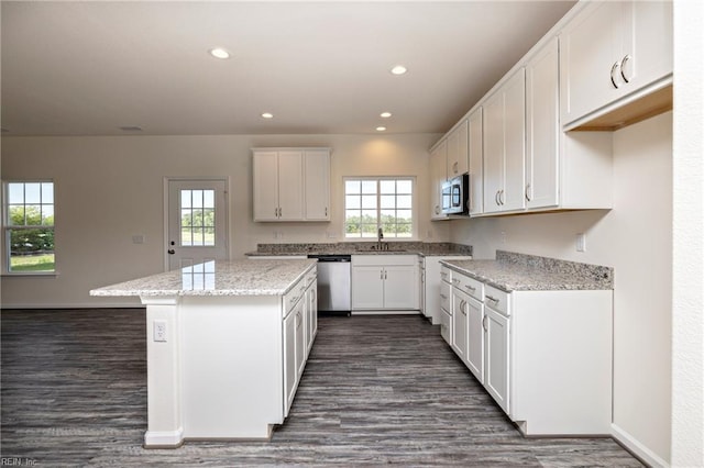 102 Corcoran Ln, Suffolk, VA 23434 - kitchen with appliances with stainless steel finishes, a sink, a center island, dark wood-style floors, and white cabinets