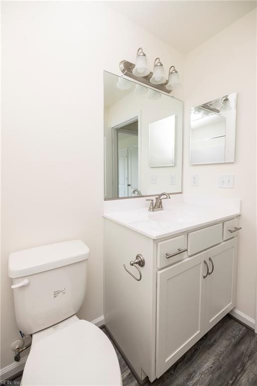 102 Corcoran Ln, Suffolk, VA 23434 - half bathroom with toilet, vanity, baseboards, and wood finished floors