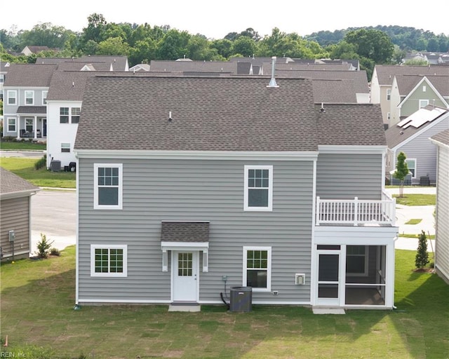 102 Corcoran Ln, Suffolk, VA 23434 - rear view of house featuring roof with shingles, a lawn, a balcony, and a residential view