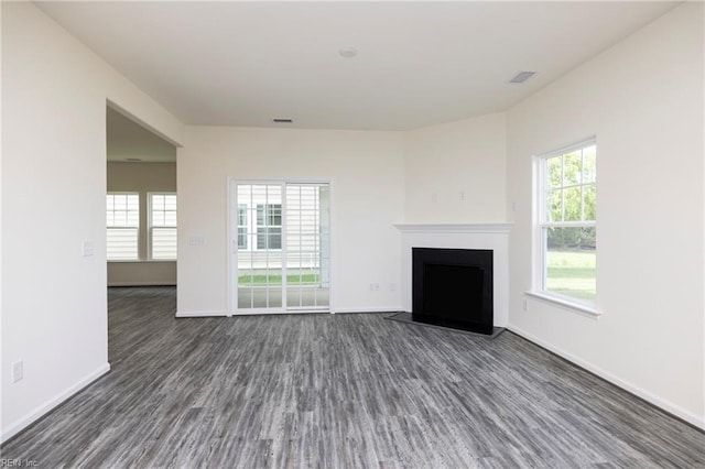 102 Corcoran Ln, Suffolk, VA 23434 - unfurnished living room featuring dark wood-style flooring, a fireplace with flush hearth, and baseboards