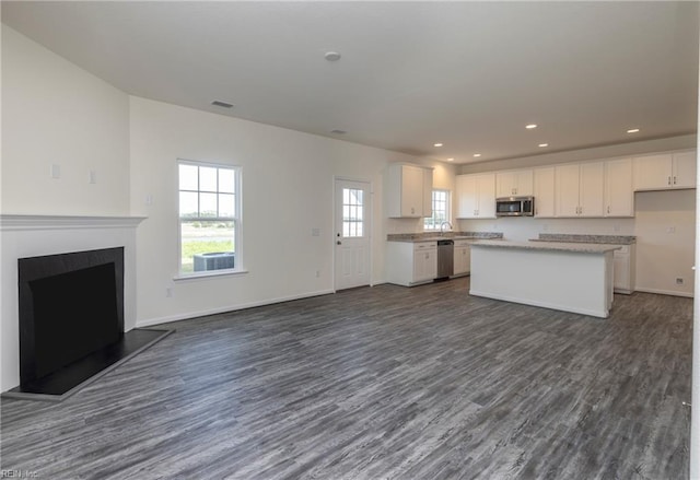 102 Corcoran Ln, Suffolk, VA 23434 - kitchen with stainless steel appliances, open floor plan, dark wood-type flooring, white cabinetry, and recessed lighting