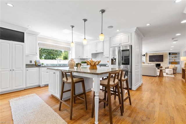 1825 N Alanton Dr, Virginia Beach, VA 23454 - kitchen with stainless steel refrigerator with ice dispenser, white cabinets, light wood finished floors, recessed lighting, and ornamental molding