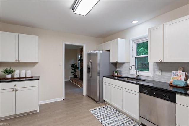 3408 Wakefield Dr, Portsmouth, VA 23703 - kitchen with appliances with stainless steel finishes, a sink, dark countertops, decorative backsplash, and white cabinets