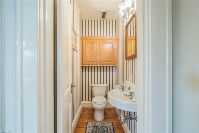 3 Acorn St, Hampton, VA 23669 - bathroom featuring wallpapered walls, toilet, wood finished floors, baseboards, and a sink