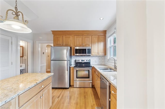 3 Acorn St, Hampton, VA 23669 - kitchen with appliances with stainless steel finishes, a sink, light stone counters, and tasteful backsplash